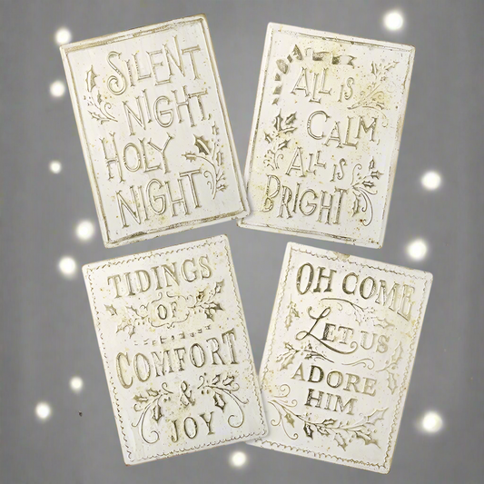 A set of four cream and gold aged effect Christmas signs with different texts, including 'Silent Night', 'All is Calm', 'Tidings of Comfort', and 'Oh Come Let us Adore Him'.