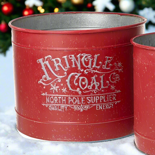A red metal bucket with 'KRINGLE COAL' printed on the side in white, faux snow, and a Christmas aesthetic.