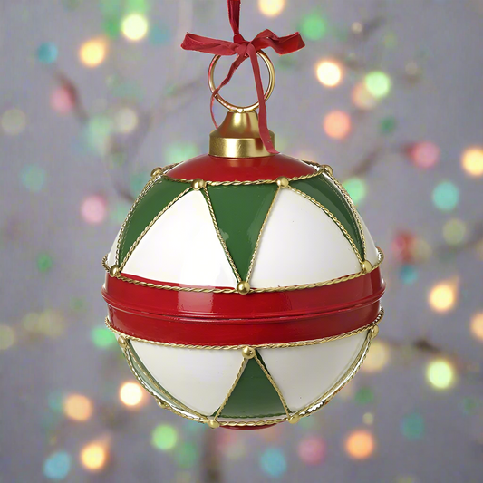 A round Christmas ornament with red, green, white, and gold geometric patterns, featuring a gold top and a red ribbon hanger.