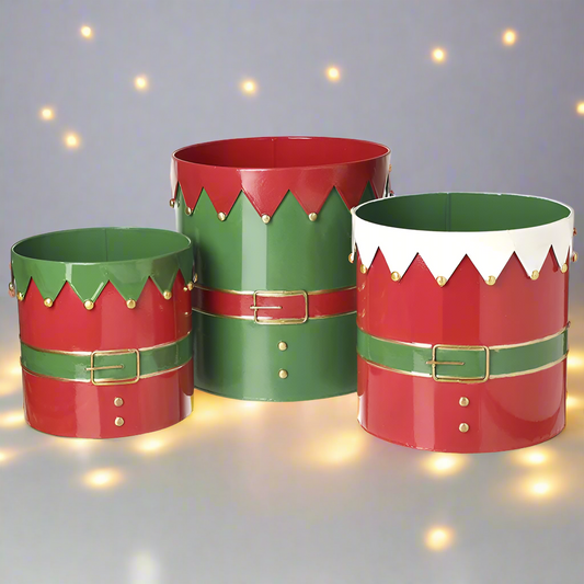 Set of 3 cylindrical metal containers with a festive design, featuring red, green, and white colors, resembling elf outfits.