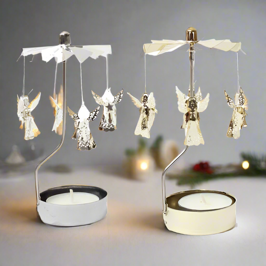 Two angel tea light spinners with metal frames, one with a gold finish and the other with a silver finish. Each has a spinning mechanism with angel figurines and is designed to hold a tea light candle at the base.