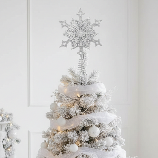 A silver glittery snowflake-shaped ornament designed to be hung on the top of a Christmas tree.
