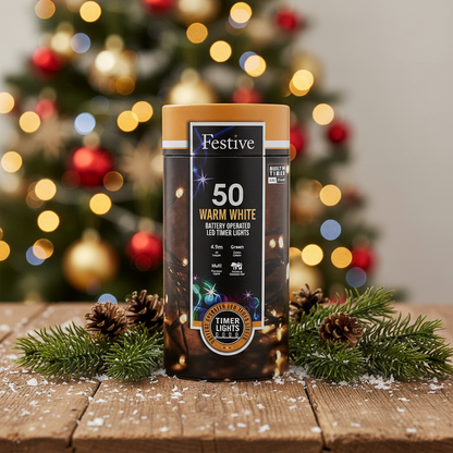 A cylindrical package of Festive 50 Warm White battery-operated string lights with a timer function. The packaging is predominantly brown and white, featuring images of the lights and a Christmas tree.