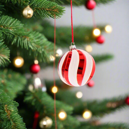 Red and white striped Christmas ornament in a box labeled 'Festive Waterproof Decorations'.