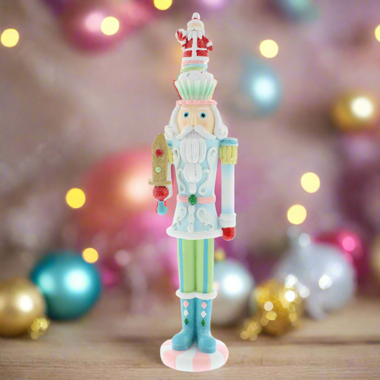 A pastel-colored Christmas nutcracker figurine with a cupcake design, standing 40cm tall.
