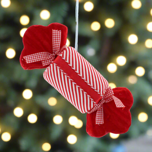 A 30cm long red and white striped candy cane-shaped Christmas decoration with a red ribbon bow on top.