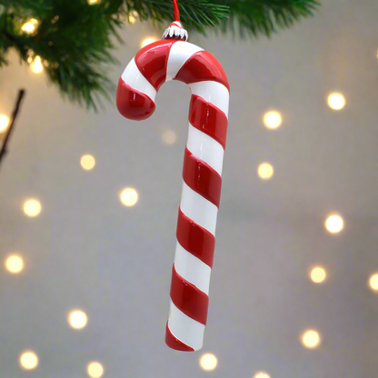 Red and white striped candy cane ornament on a white background