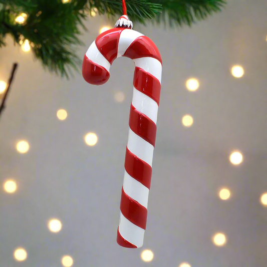 Red and white striped candy cane ornament on a white background