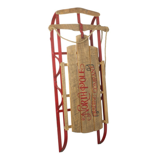 Wooden sled with red frame and 'North Pole Sledging Company' branding on a white background