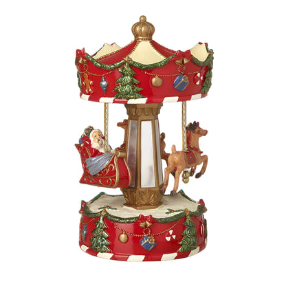 A decorative Santa Sleigh Spinning Christmas Merry Go Round with Santa and reindeer figures, decorated with red and green accents on a 25cm tall ornately decorated base.