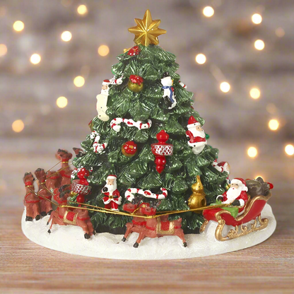 A musical Christmas tree ornament featuring Santa Claus and a sleigh at its base, with a revolving mechanism.