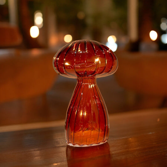 Decorative glass vase on a wooden surface with blurred background