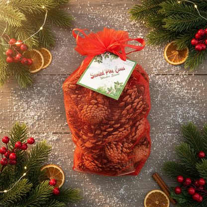 A red bag filled with pinecones, tied with a ribbon, set against a festive holiday-themed backdrop with Christmas decorations.