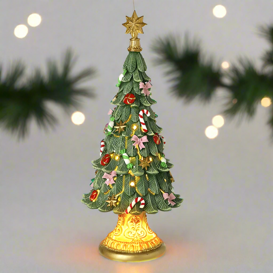A decorative Christmas tree ornament with a gold plinth base, adorned with green foliage, red berries, gold accents, and topped with a gold star.