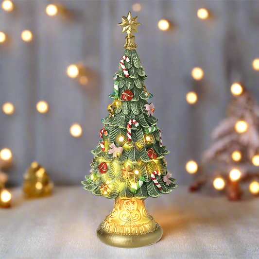 A decorative Christmas tree ornament with multicolored ornaments and a gold star on top, set on a golden plinth.