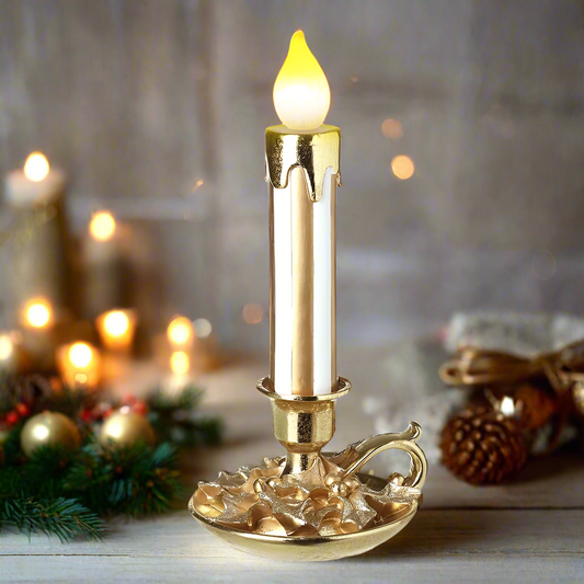 A gold-colored LED lighted candle stick with a flame effect, placed on a decorative base.