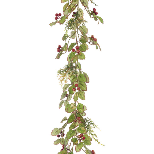 Artificial greenery with red berries on a white background