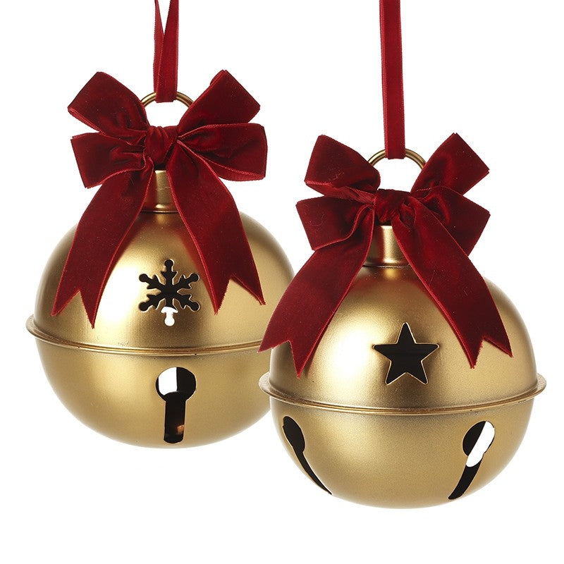 Two gold jingle bells with red velvet bows on a white background
