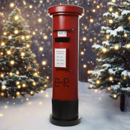 A vintage style red Christmas post box with a black base, featuring text and decorative elements.