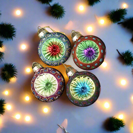 Colorful Christmas vintage baubles with a festive background of lights and greenery.