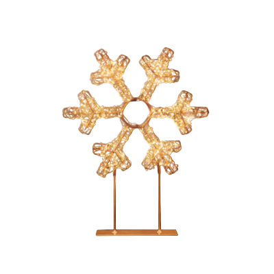 Decorative snowflake light on a stand against a black background